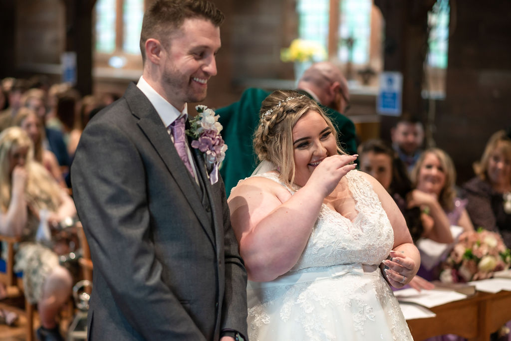 Runcorn church wedding magic! Bride & groom's laughter lights up the aisle. #WeddingMemories #CheshireLoveStory