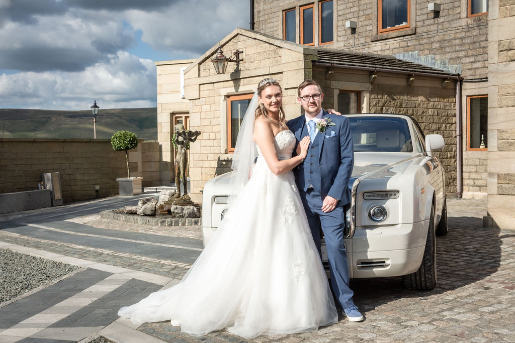 Elegant Bride and Groom Pose by Luxurious Rolls Royce at Saddleworth Hotel Wedding Venue