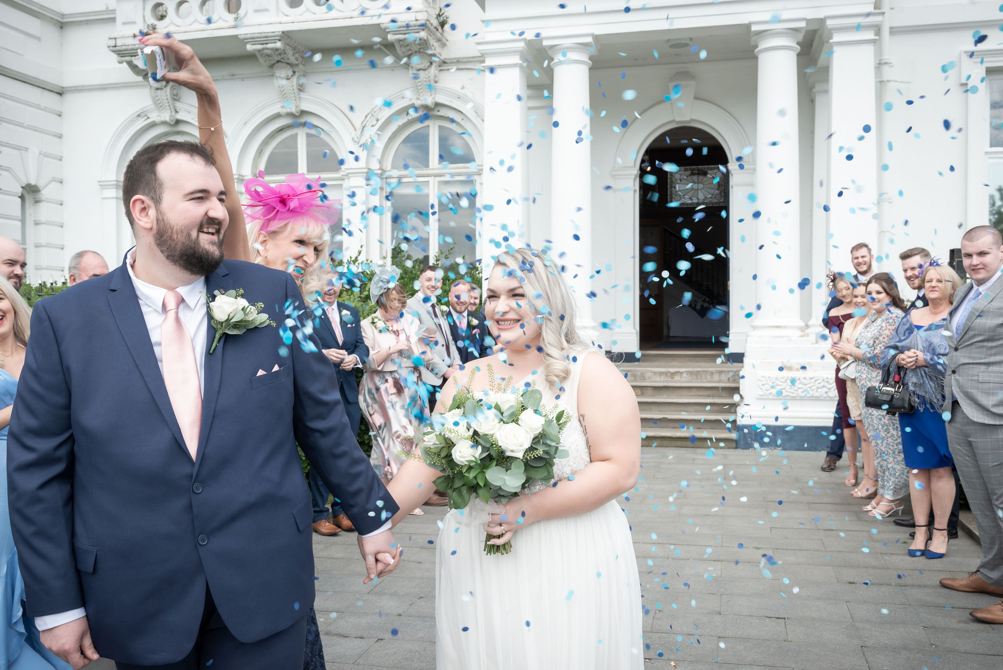 Picture perfect! Confetti rains down on beaming bride & groom exiting Runcorn Town Hall. #JustMarried #RuncornWeddings