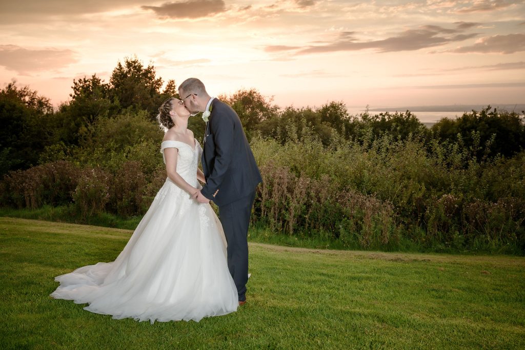 husband and wife kissing each other during the sunset at their wedding day at Forest Hills Hotel in Frodsham, Cheshire