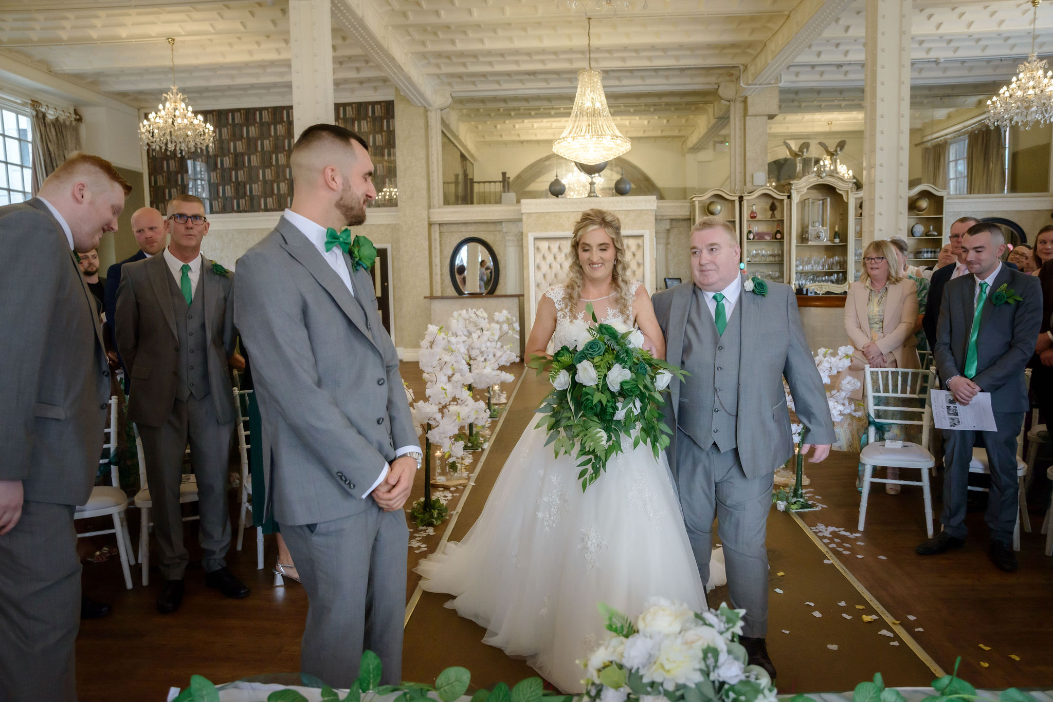 Liverpool wedding magic: emotional bride walks down aisle with proud dad to meet groom. #LiverpoolWedding #WeddingPhotography