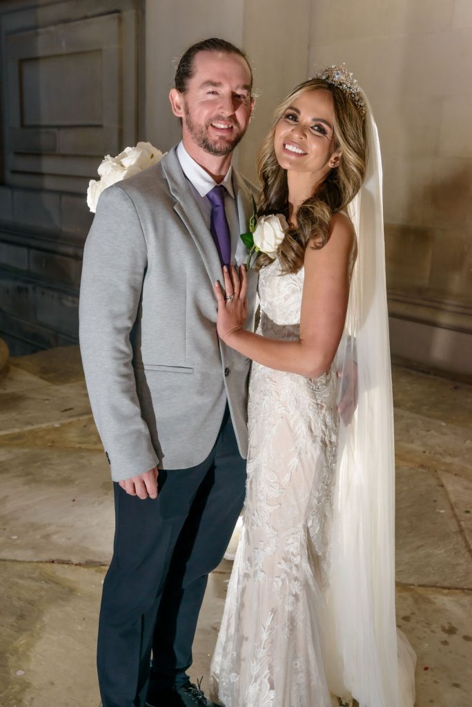 Enchanting twilight wedding photo of a radiant bride and elegant groom at Liverpool's iconic St. George's Hall.