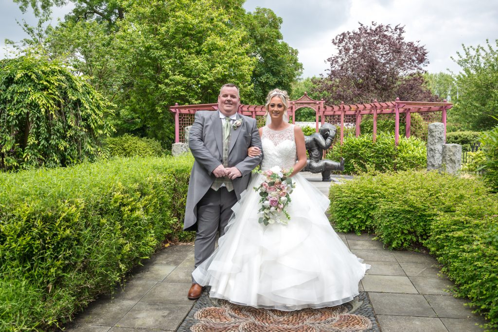 bride and groom stood arm in arm in the Chinese Peace Garden at Runcorn Town Hall during their wedding day | Michael Pardoe | Cheshire Wedding Photographer